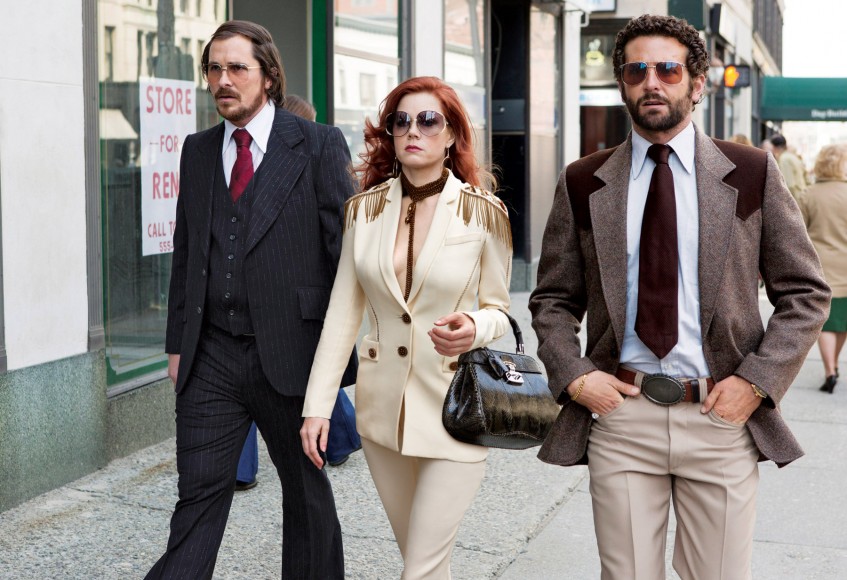 Amy Adams in American Hustle, 2013.  Suit and necklace by Versace, 2014.